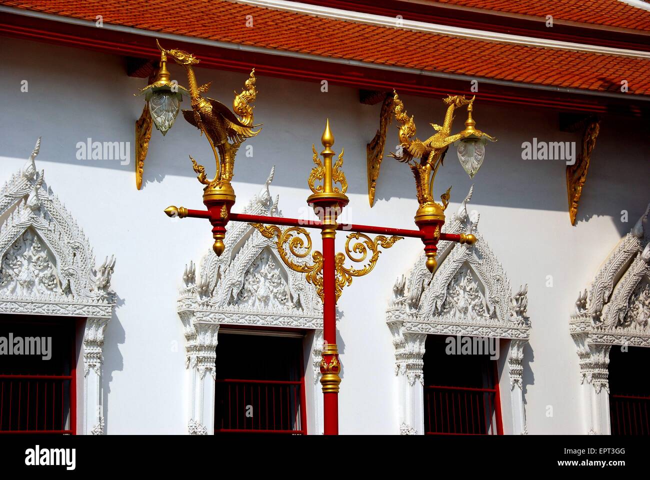 Bangkok, Thailand:  Gilded mythical birds holding glass lanterns atop a lamp post at Wat Mahathat   * Stock Photo