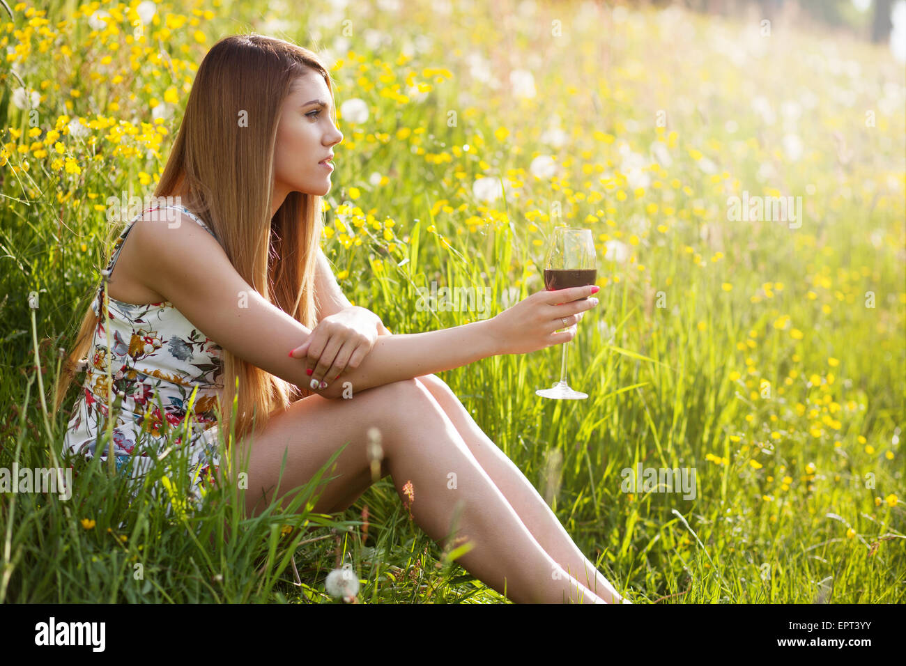 Young beautiful woman drinking wine outdoors Stock Photo