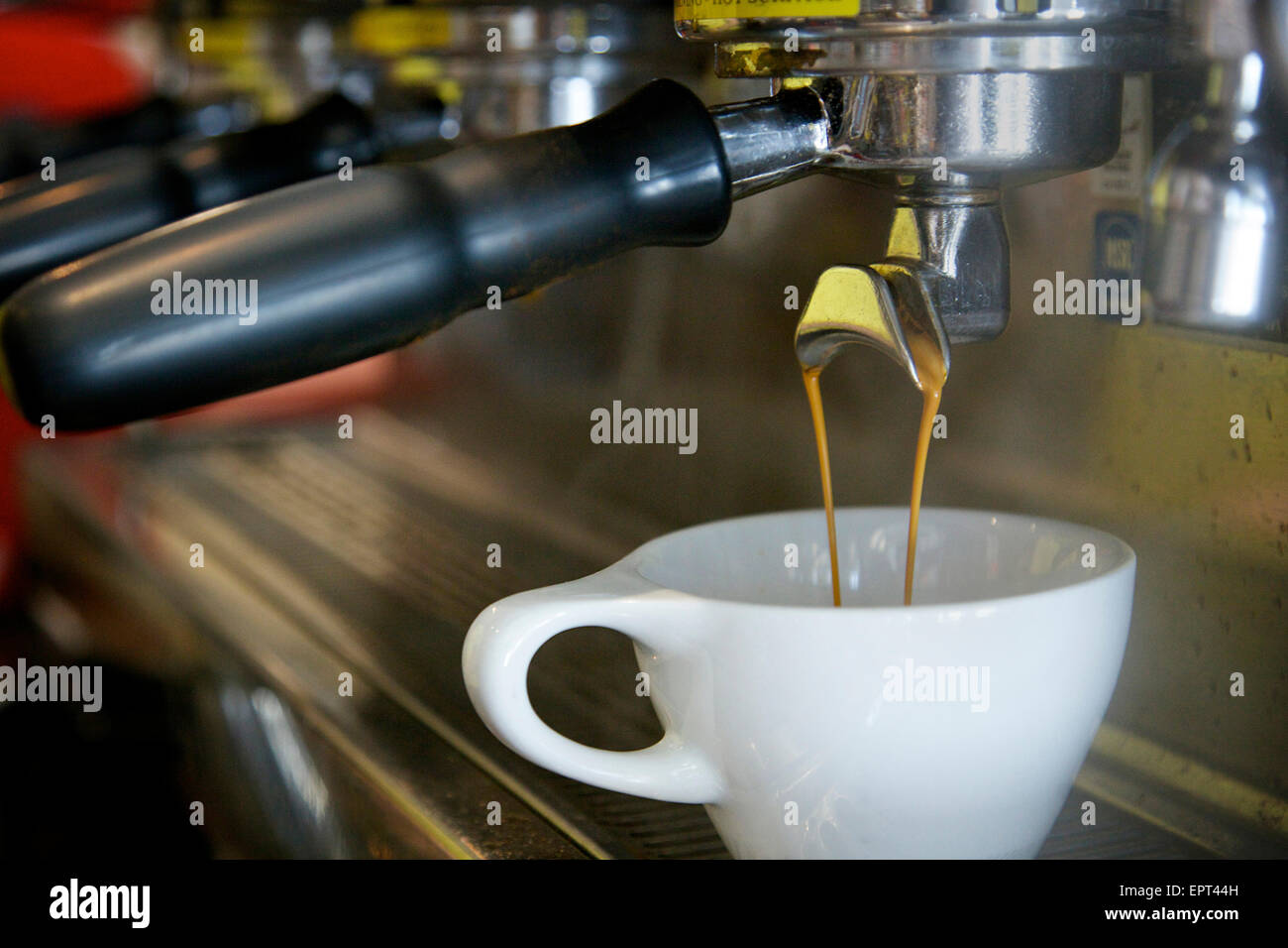 Espresso Pouring into White Cup Stock 