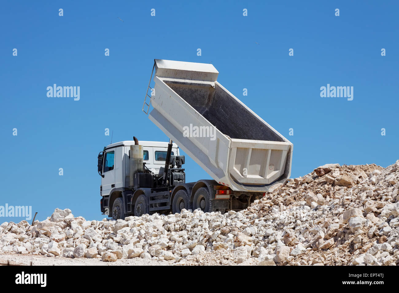 tipper truck unload crushed rocks Stock Photo
