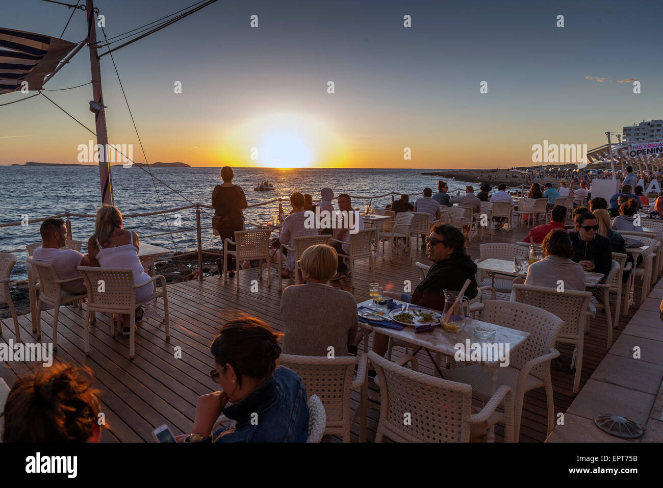 SAN ANTONI DE PORTMANY, IBIZA - MAY 15, 2015: People meet in bars coast to see the famous sunset and fun Stock Photo