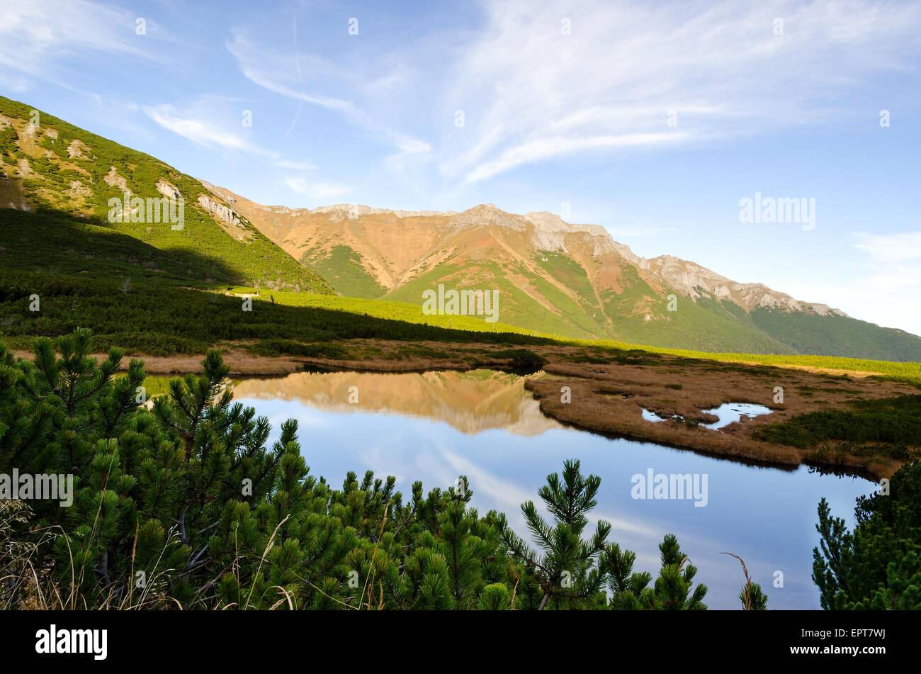Mountain landscape. View of summits reflected in lake, Tatras mountains in autumn season. Stock Photo