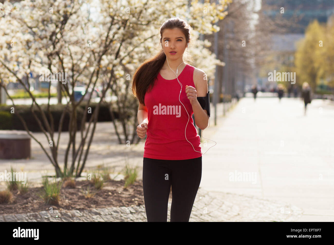 Young beautiful woman running in the city Stock Photo