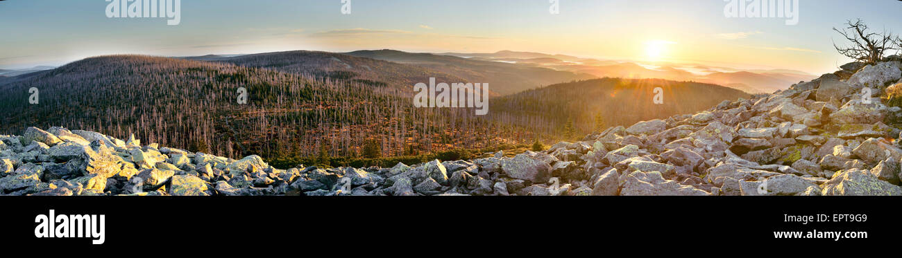 Scenic overview of a glowing, early morning sunrise over mountains with mist, Bavarian Forest National Park, Bavaria, Germany Stock Photo