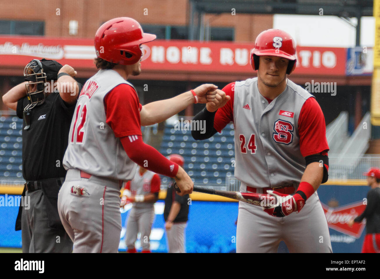 first baseman Preston Palmeiro (12) of the NC State Wolfpack celebrates  after scoring the first run of the ACC Baseball Tournament Game 6 NC State  vs. Notre Dame at Durham Bulls Athletic