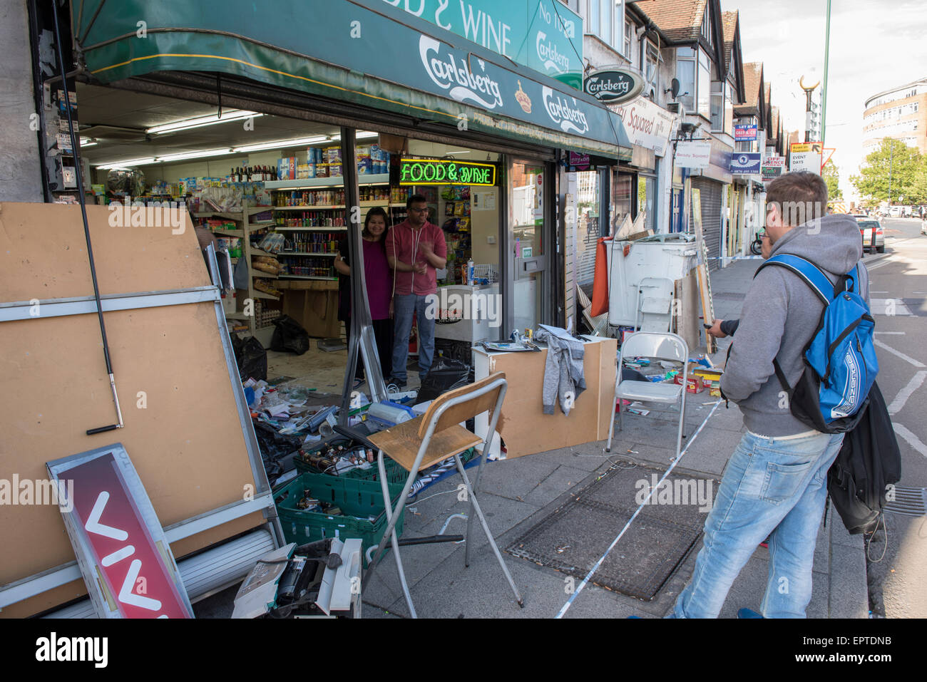 London, UK. 21st May 2015. Owners begin clean up after car crashes through shop front in Wembley. London, UK. Credit:  Peter Manning/Alamy Live News Stock Photo