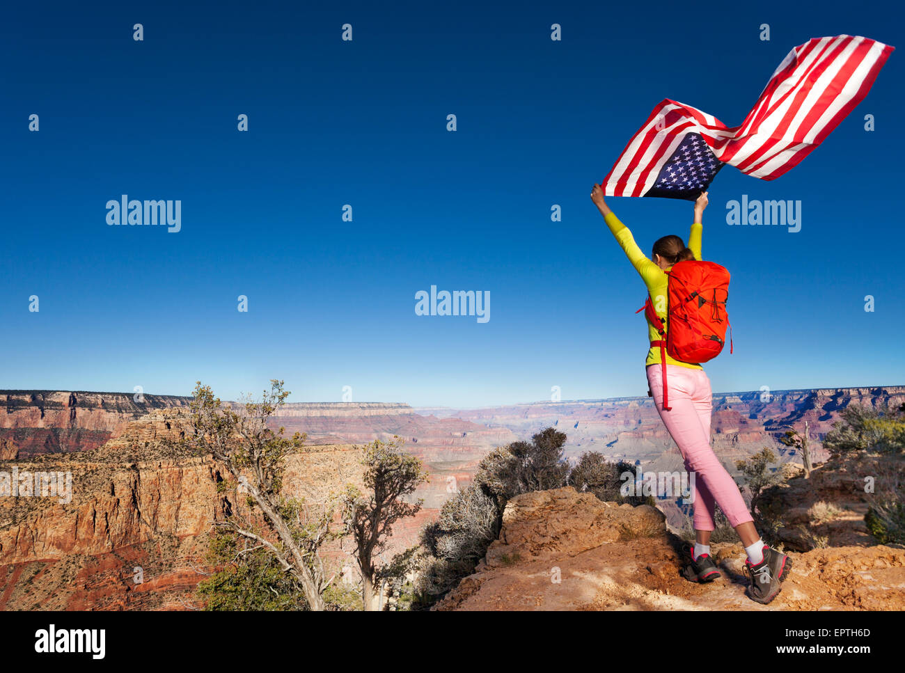 Woman and US flag on Independence Day Grand Canyon Stock Photo