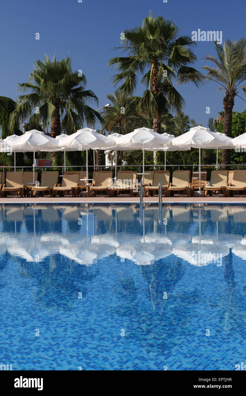 Chairs and umbrellas near swimming pool Stock Photo Alamy