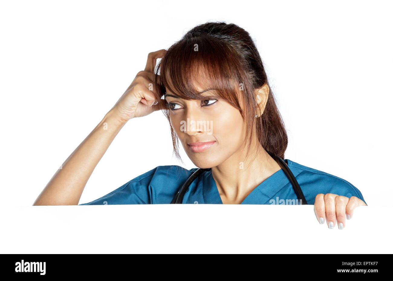 Attractive Indian doctor woman posing in a studio in front of a ...