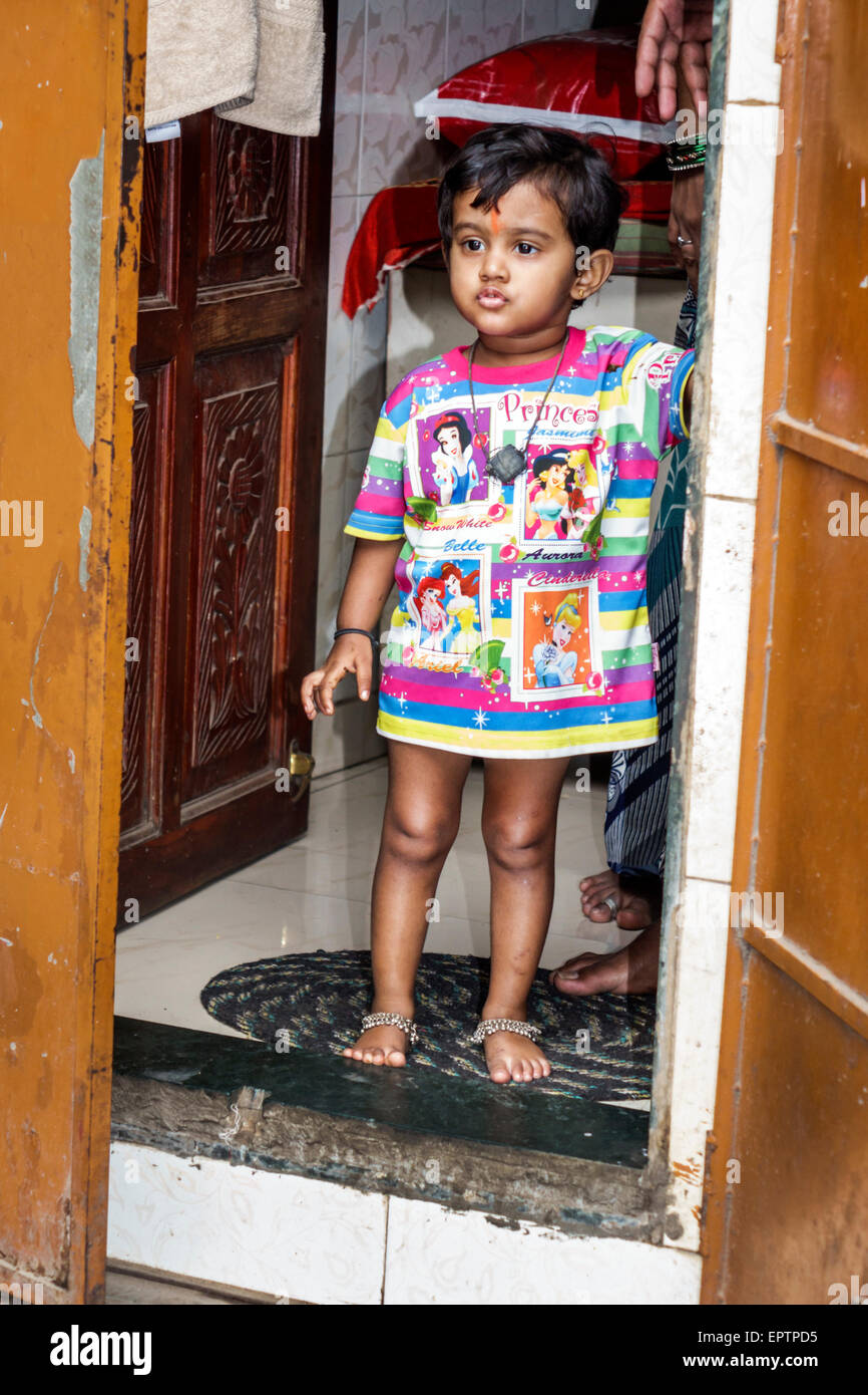 Mumbai India,Dharavi,60 Feet Road,slum,girl girls,youngster,female kids children front door,home,Hindu,bindi,Disney characters,India150228051 Stock Photo