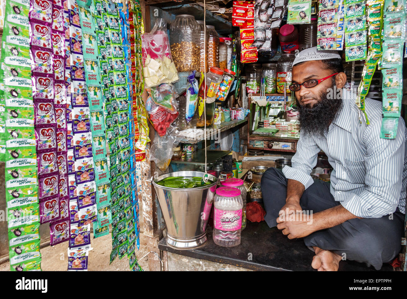 Mumbai India,Dharavi,60 Feet Road,slum,low income,poor,poverty,man men male,Muslim,convenience store,stall,owner,lotions,packets,India150228084 Stock Photo