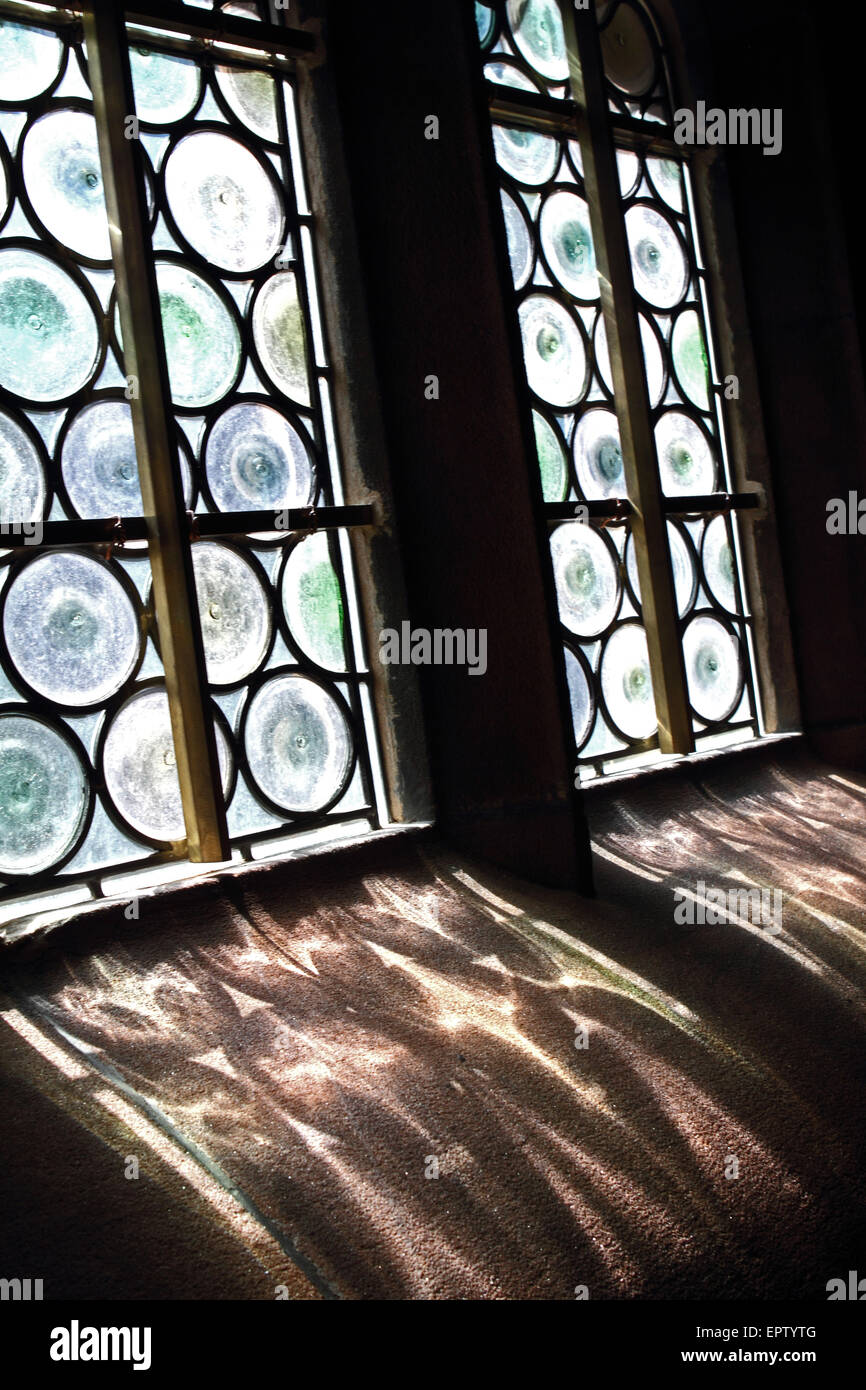 Shadow of a stained glass window on a stone window ledge Stock Photo