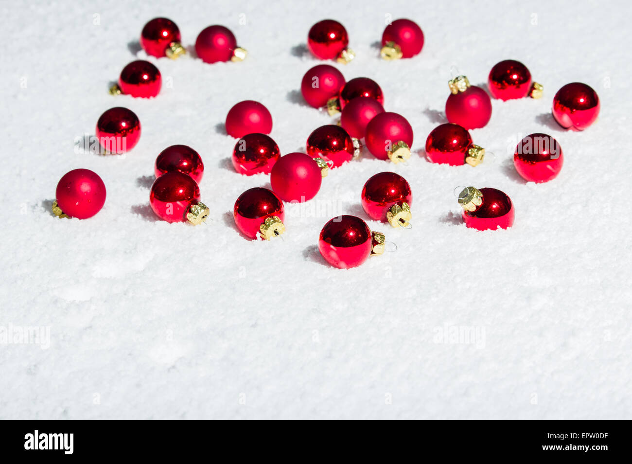 A group of shiny red Christmas ornaments on snow Stock Photo - Alamy