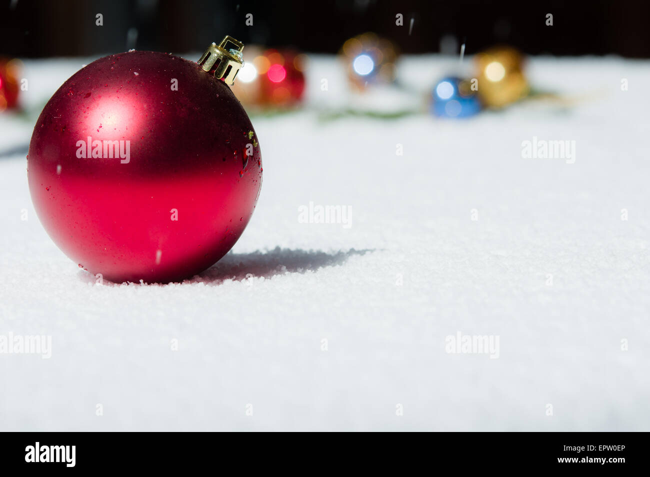 Red Christmas ball with ornaments in background Stock Photo