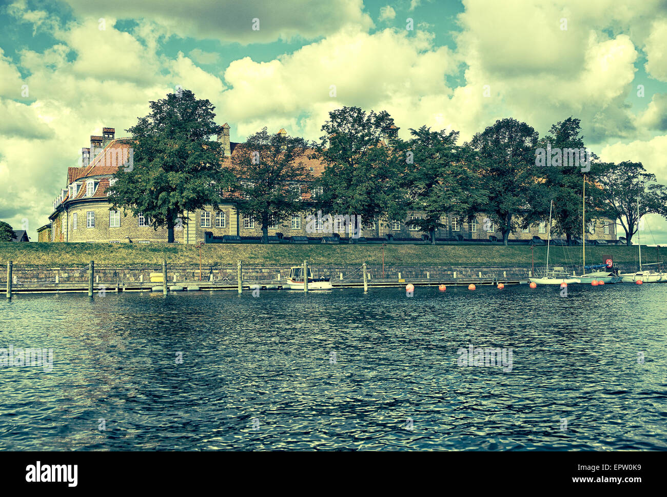 The red roof house. The viev from the channel Holmen. Copenhagen. Denmark. Vintage color style toned image. Stock Photo