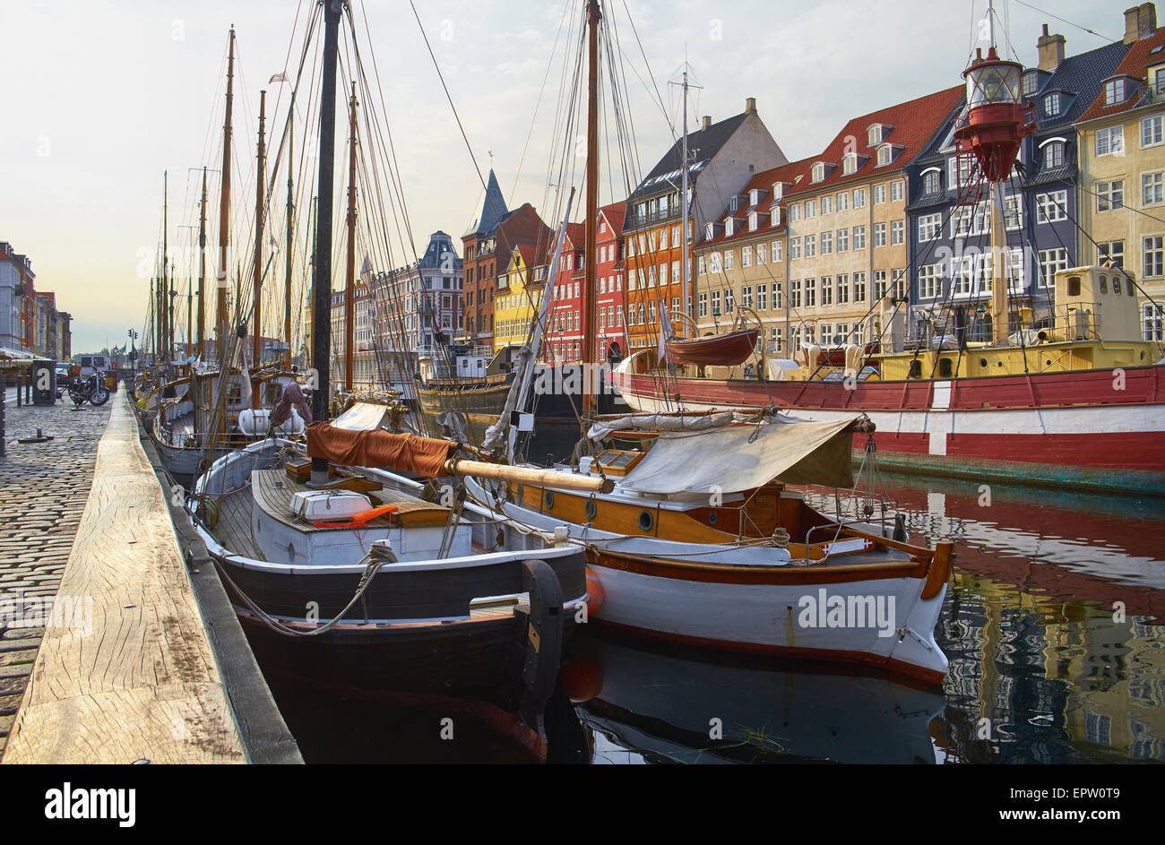 The boats and ships in the calm hurbour of Nyhavn, Copenhagen, Denmark. Nyhavn  (New Harbour) is waterfront, canal and entertain Stock Photo