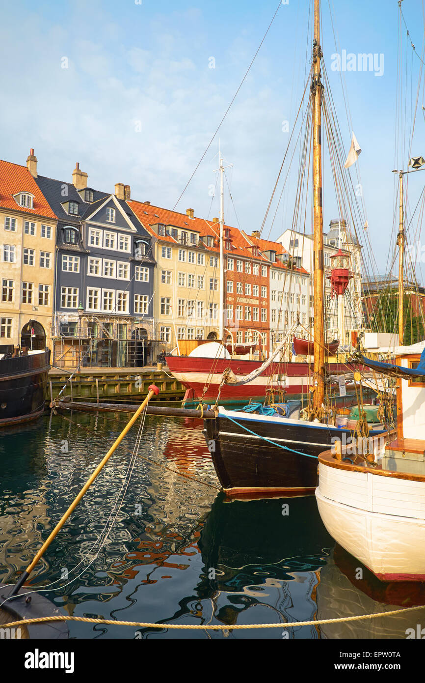 The boats and ships in the calm hurbour of Nyhavn, Copenhagen, Denmark. Nyhavn  (New Harbour) is waterfront, canal and entertain Stock Photo