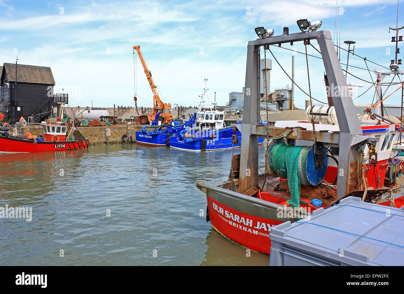 A Fishing boat in the busy harbour at Whitstable in Kent Stock Photo ...