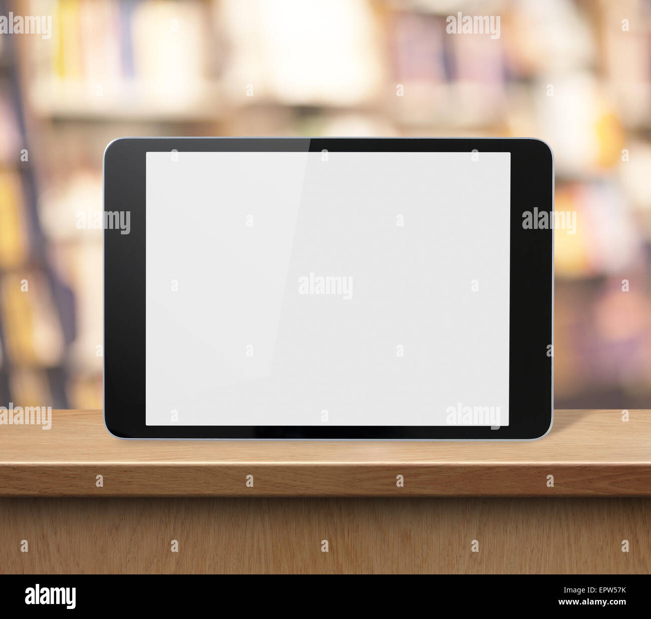 tablet PC on wood shelf in book shop or library Stock Photo