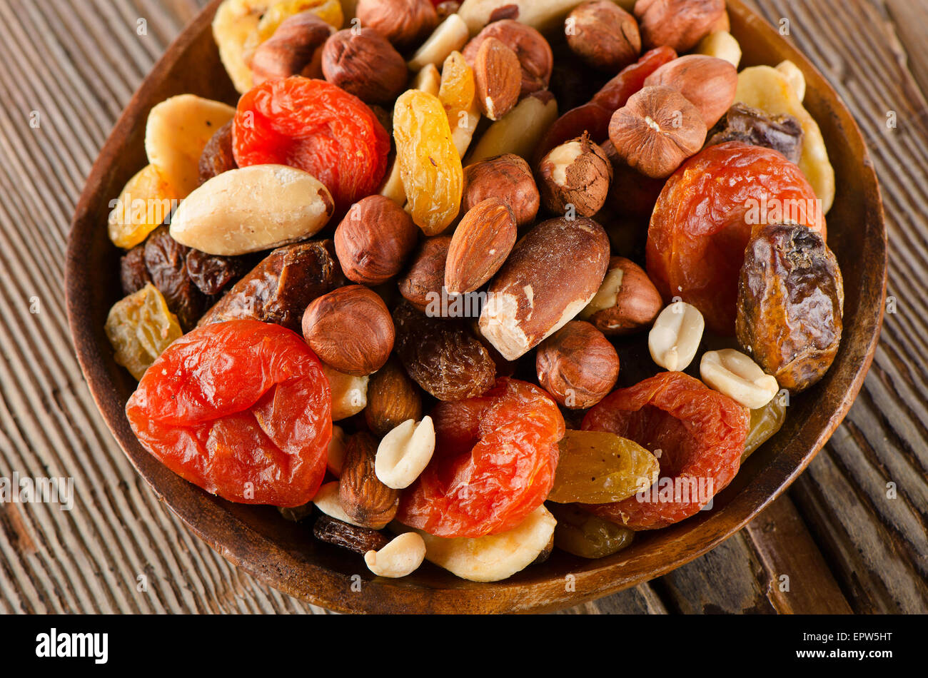 Healthy Mix nuts and dried fruits on a wooden background Stock Photo