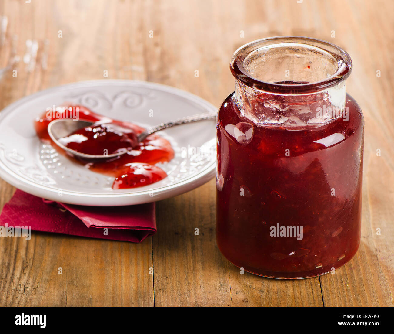 Strawberry jam on  wooden background. Selective focus Stock Photo