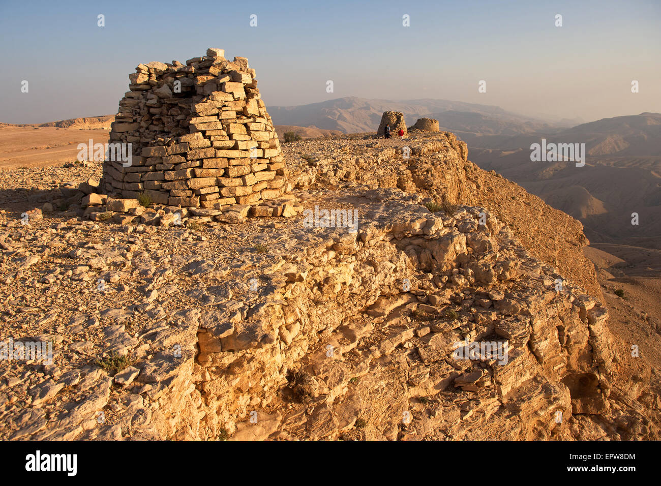 Lined up dramatically atop a rocky ridge, the Beehive Tombs of Bat, in Oman, are a Unesco World Heritage Site. Stock Photo