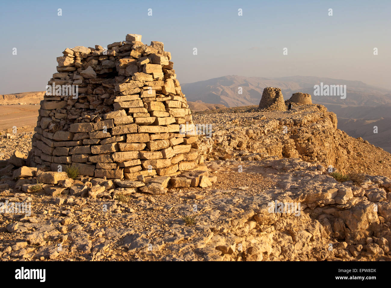 Lined up dramatically atop a rocky ridge, the Beehive Tombs of Bat, in Oman, are a Unesco World Heritage Site. Stock Photo