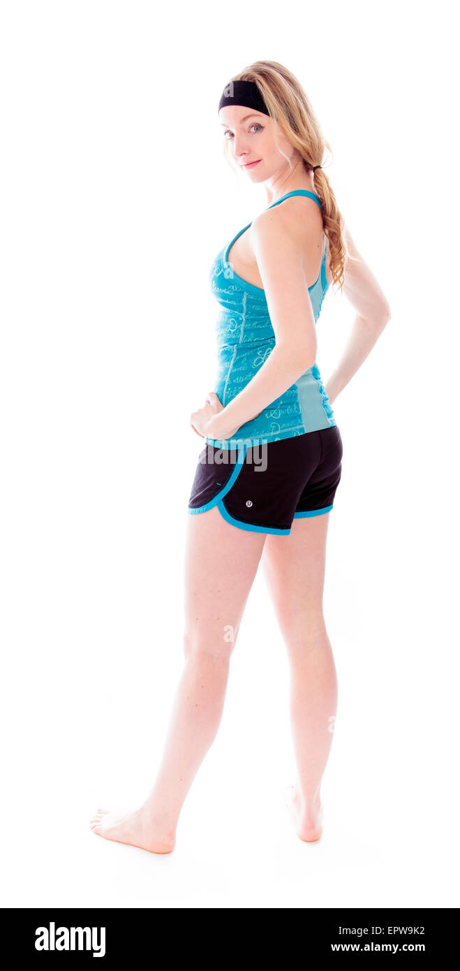 Full body shot of slim sportive woman with her arms akimbo Stock