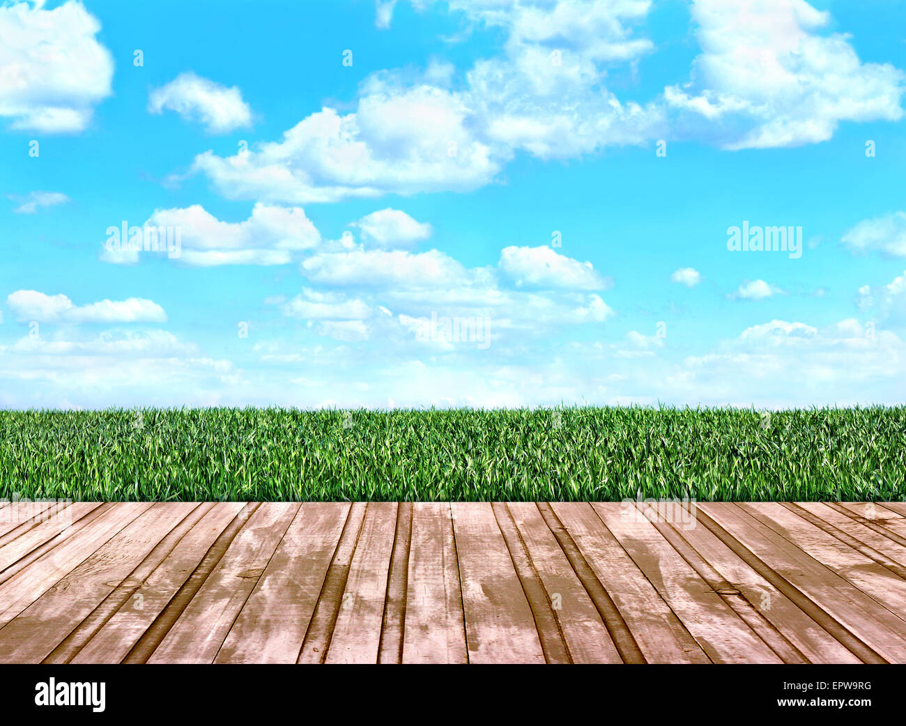 wooden floor boards that go on the field with green grass Stock Photo