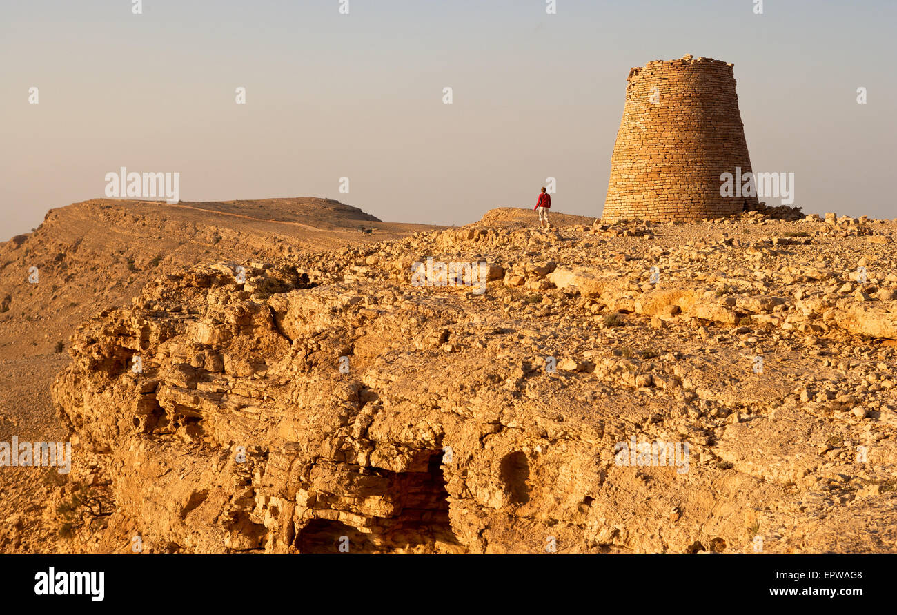 One of the Beehive Tombs of Bat, perched dramatically atop a rocky ridge in Oman. The tombs are a Unesco World Heritage Site. Stock Photo