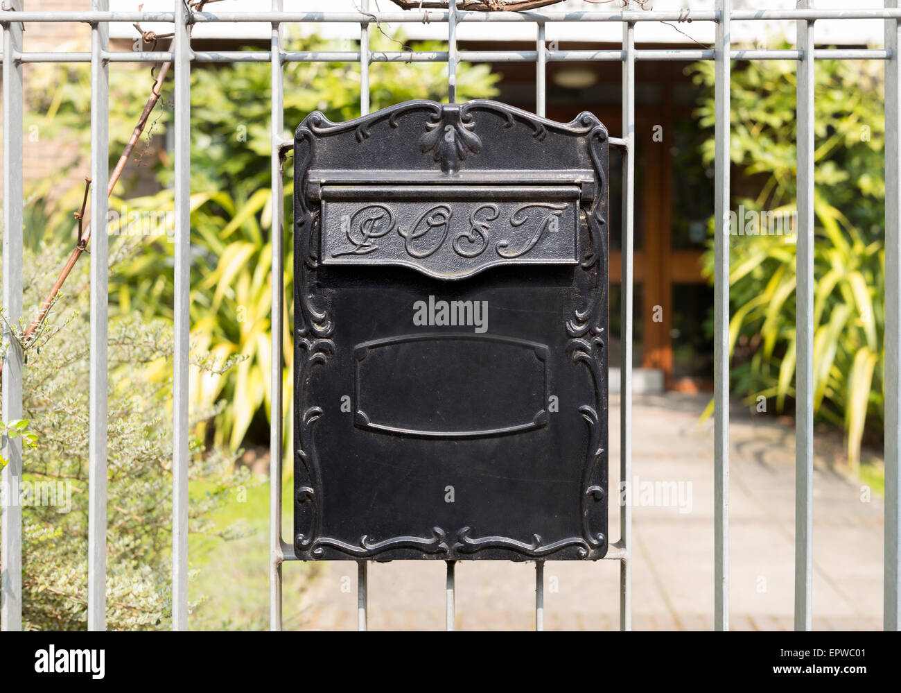 Close up Black Metal Post Box in Vintage Style Hanging on Railings or