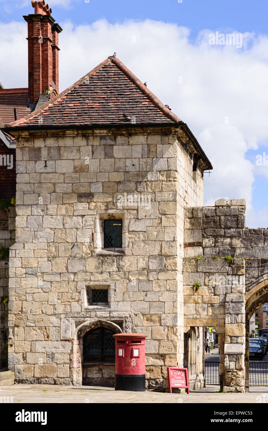 The ancient gate house at Gillygate, York. A red Royal Mail post box in