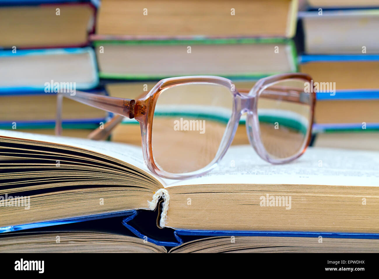 reading glasses lying on the open book Stock Photo Alamy