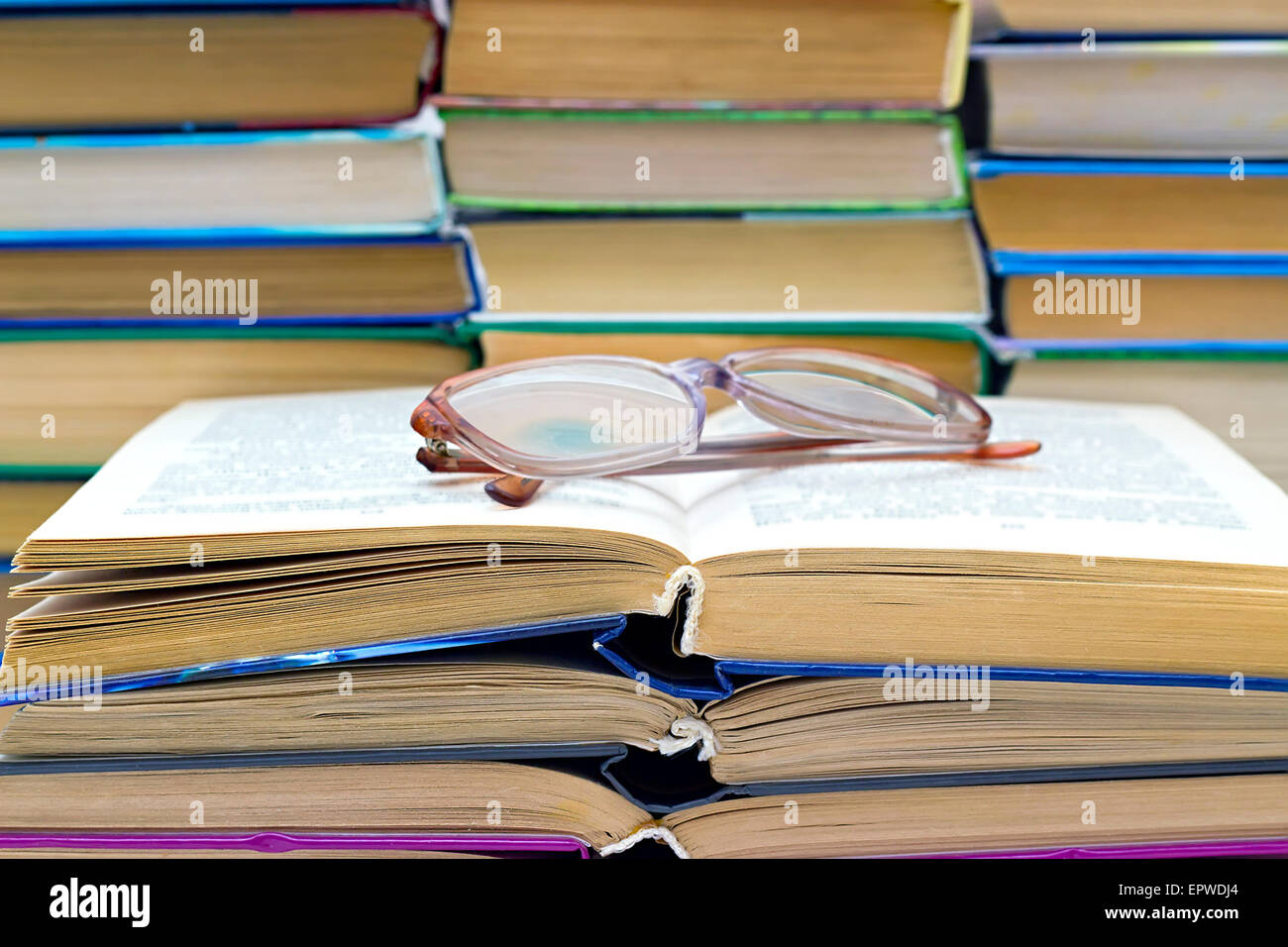 reading glasses lying on the open book Stock Photo Alamy
