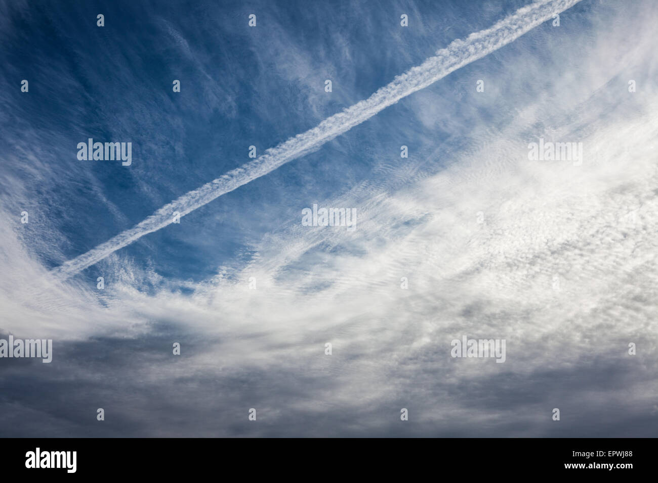 Contrail and cloudscape Stock Photo