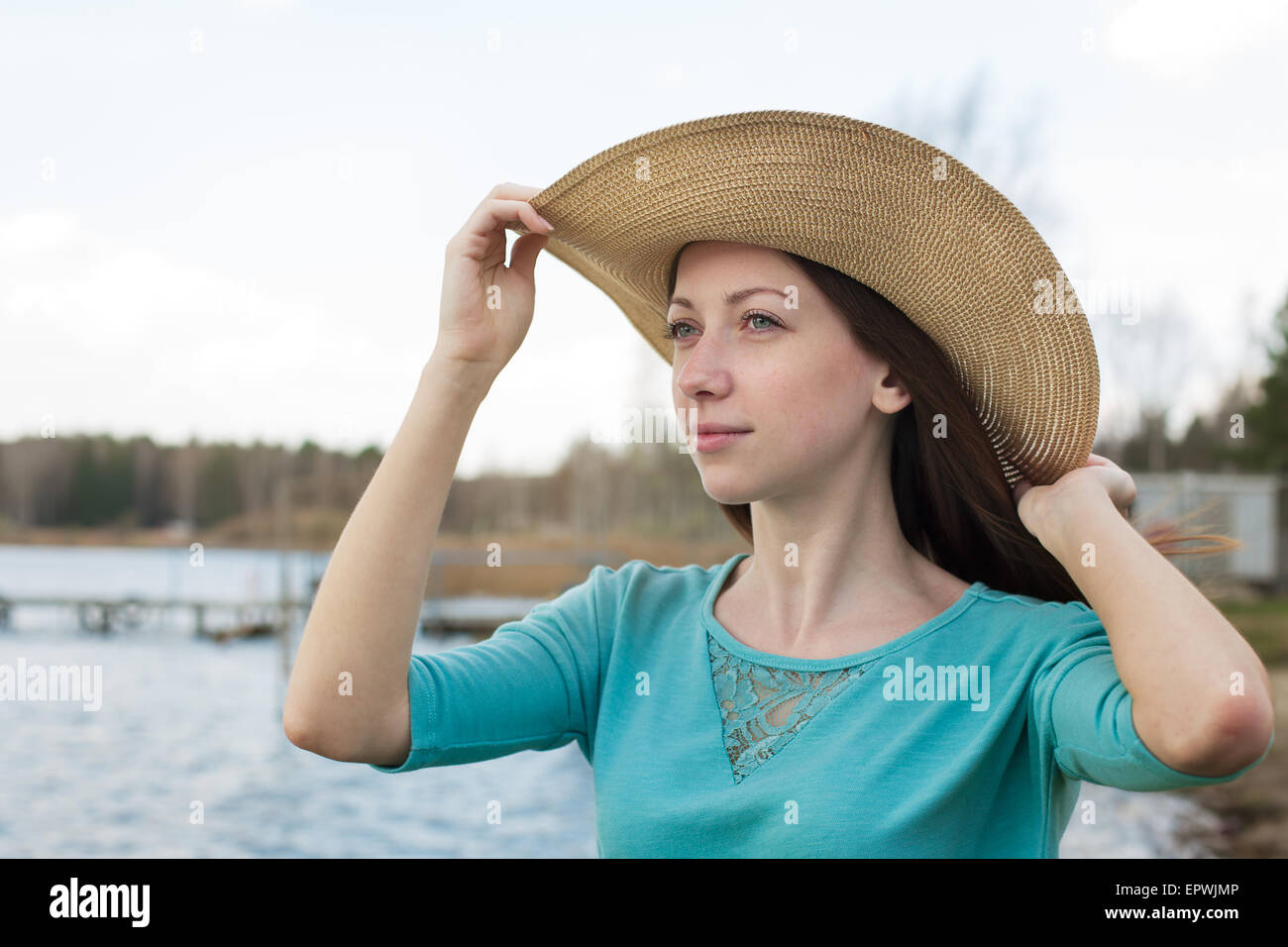 Freckled happy girl in hat dreaming on a windy day Stock Photo