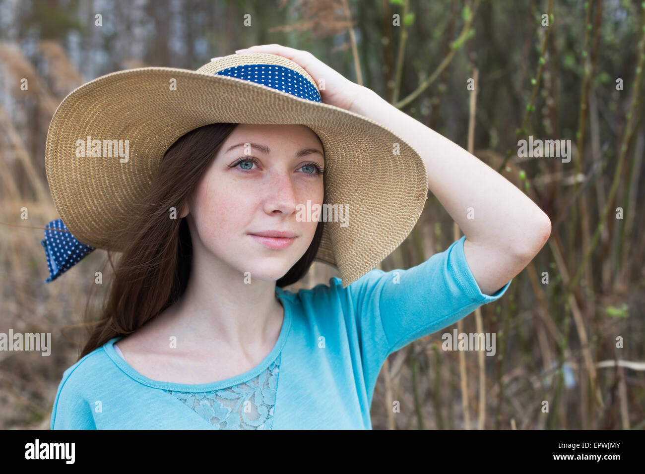 Freckled happy girl in hat in windy weather Stock Photo