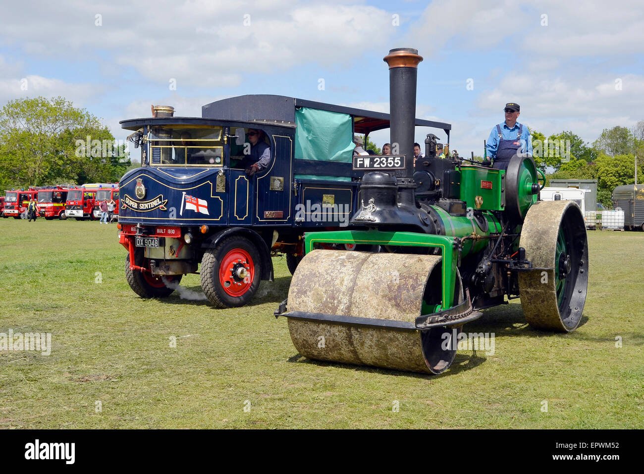 A steam roller (steamroller) and a sentinel steam lorry at a country steam fair. Stock Photo
