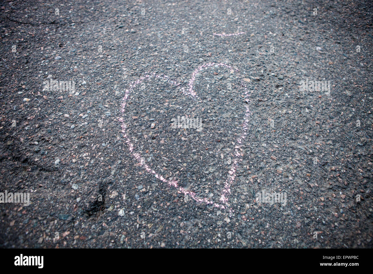 Heart shape drawind on the ground made with street chalk Stock Photo