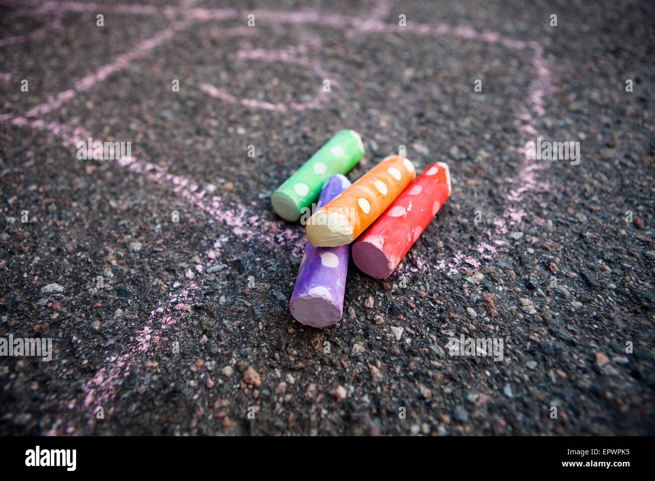 Colorful street chalk on asphalt and hopscotch drawn to the ground with them Stock Photo