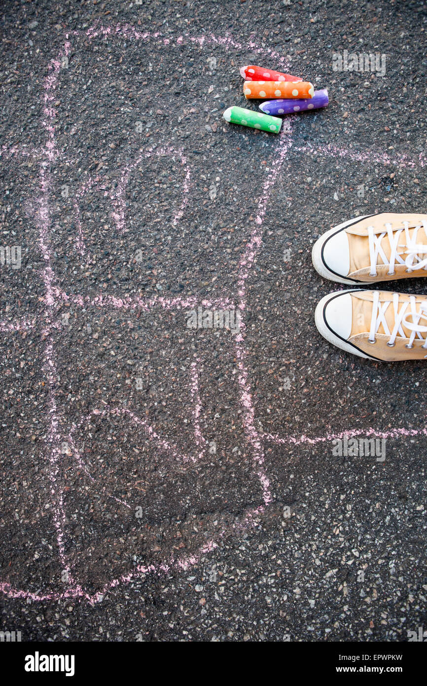 Hopschotch and colorful street chalk on asphalt Stock Photo