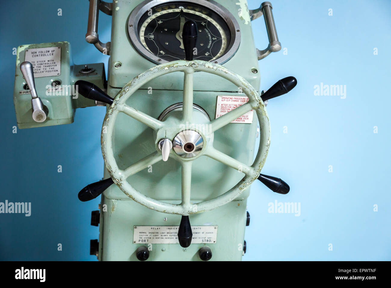 Old ship autopilot with gyrocompass repeater and steering wheel Stock Photo