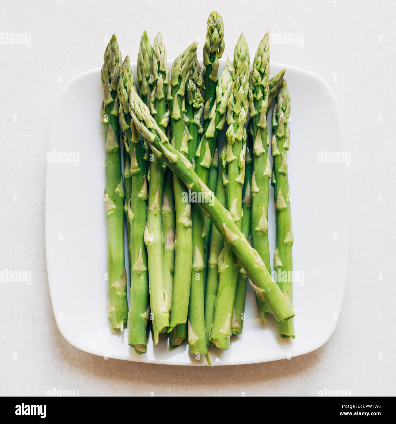 Plate filled with raw asparagus Stock Photo
