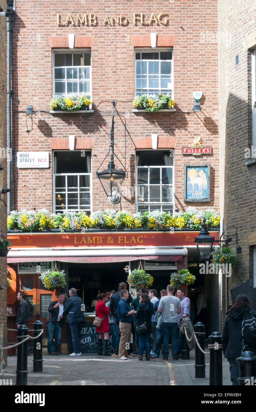 People drinking outside the historic Fuller's pub, the Lamb & Flag in Rose Street, Covent Garden, London. Stock Photo