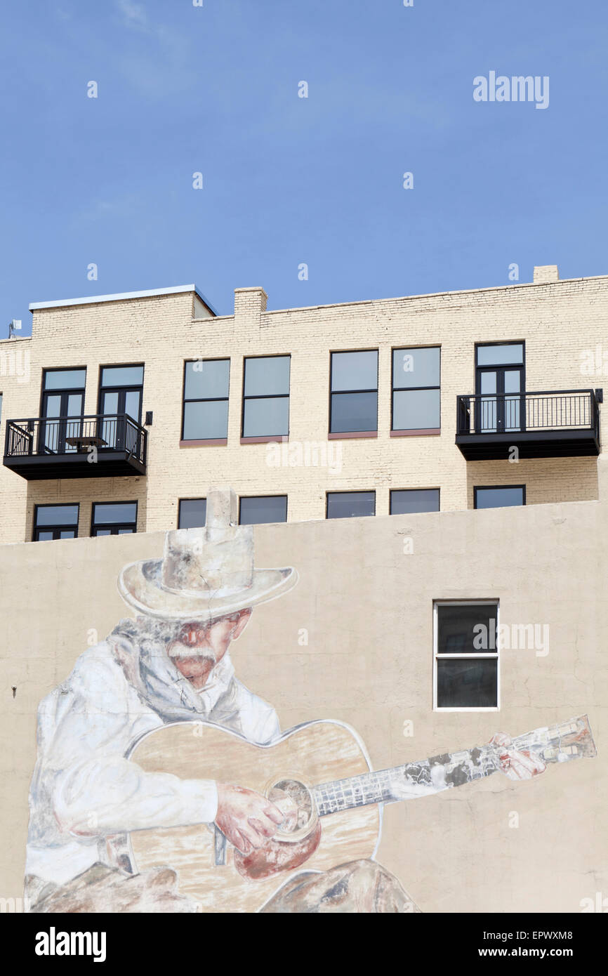 Giant wall mural of a cowboy playing guitar, Downtown Denver, Colorado, USA. Stock Photo