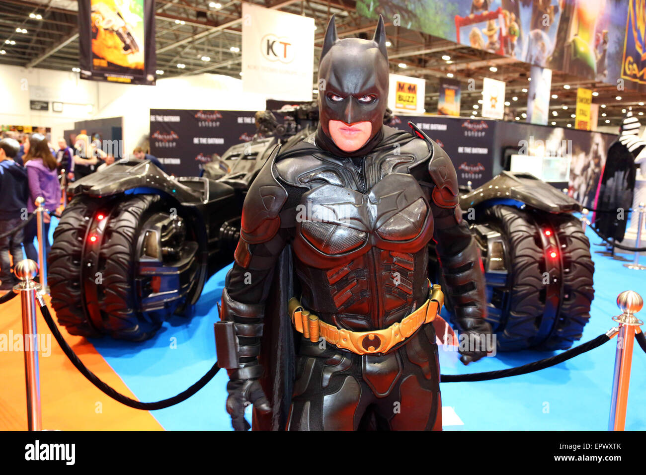 London, UK. 22nd May 2015. A fan dressed as Batman poses in front of the Batmobile at MCM Comic Con at Excel in London where fans dressed up in fantastic costumes as their favourite comic, film, cosplay or fantasy character while they enjoyed a great convention catering to old favourites and new. Credit:  Paul Brown/Alamy Live News Stock Photo