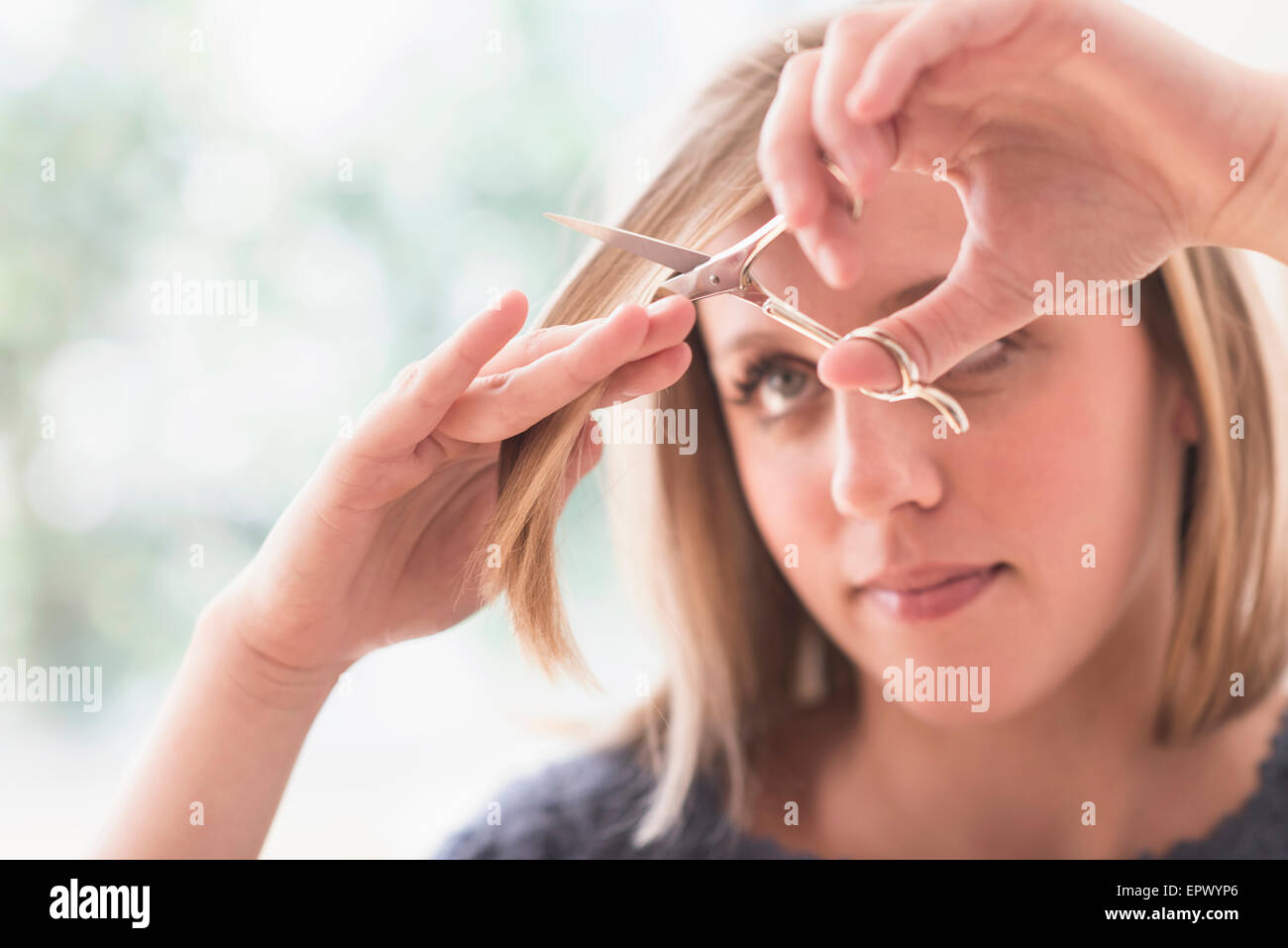 Woman cutting hair Stock Photo