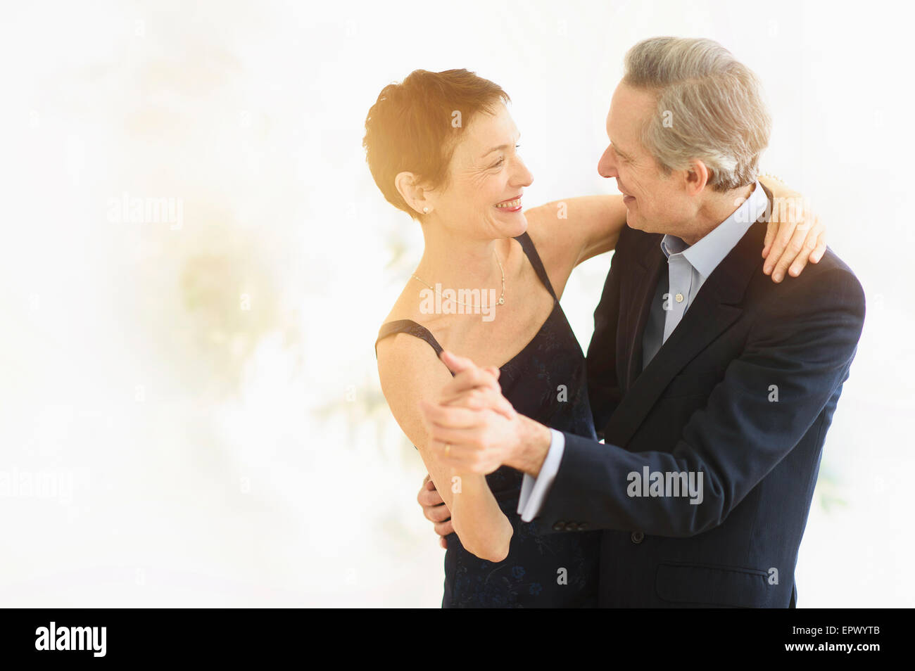 Elegant senior couple dancing while celebrating their anniversary Stock Photo
