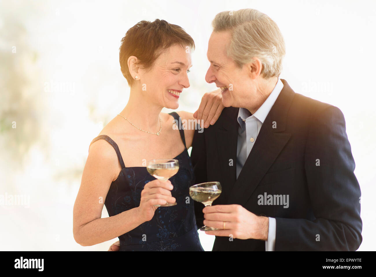 Elegant senior couple celebrating their anniversary with champagne toast Stock Photo