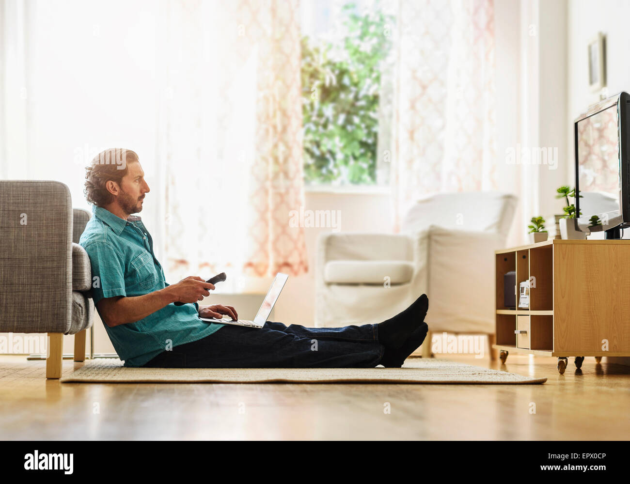 Mature man watching tv Stock Photo